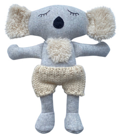 Knitted koala toy with pom-pom ears on a white background