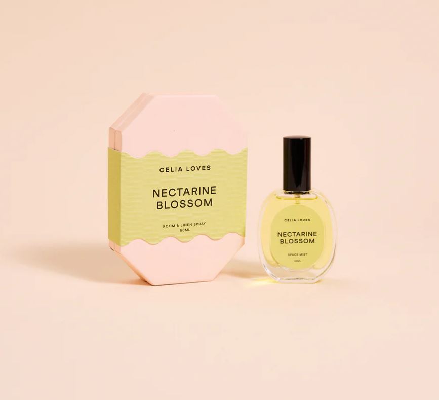 Celia Loves Nectarine Blossom room spray bottle and packaging on a light pink background