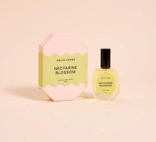 Celia Loves Nectarine Blossom room spray bottle and packaging on a light pink background