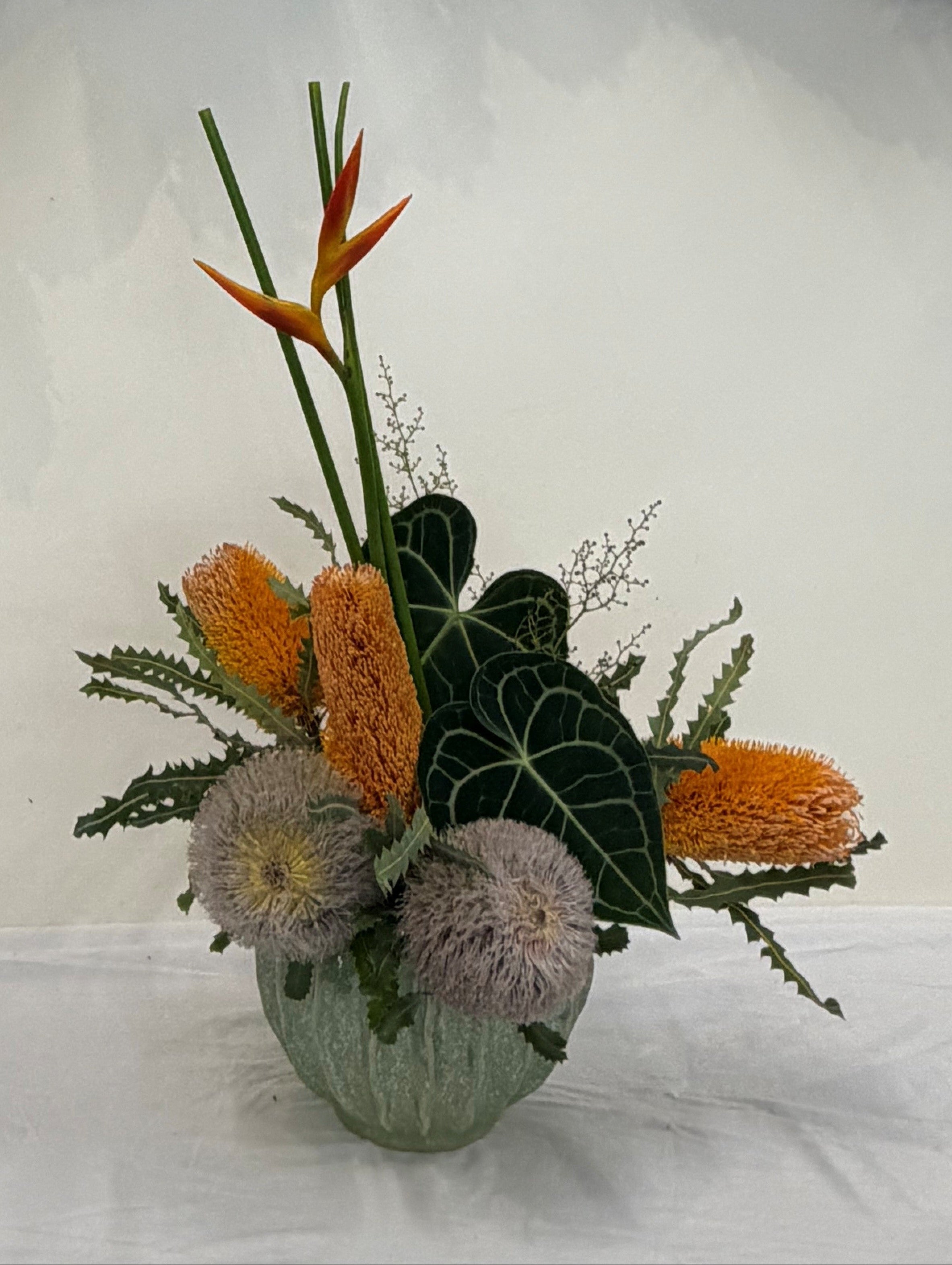 Floral arrangement with a wreath of dried flowers on a white background