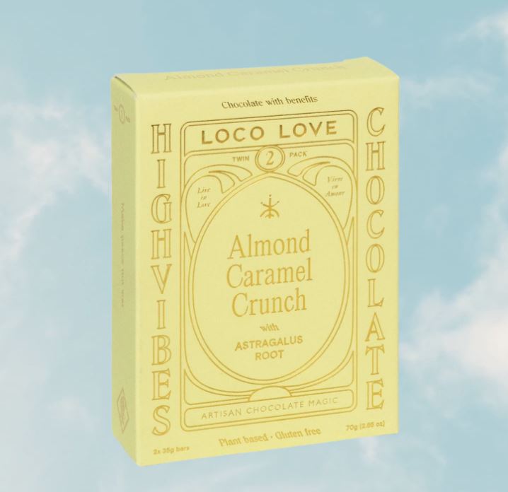 Yellow box of Loco Love High Vibes Chocolate with Almond Caramel Crunch on a blue sky background