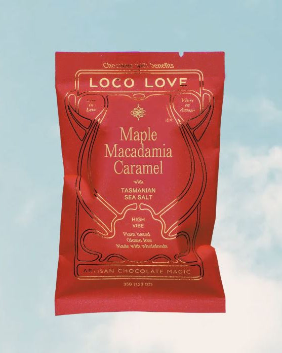 Red packaging of Loco Love Maple Macadamia Caramel with a blue sky background