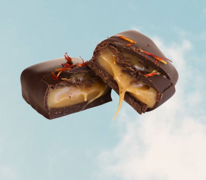 Chocolate-covered candy with a caramel filling on a light blue background