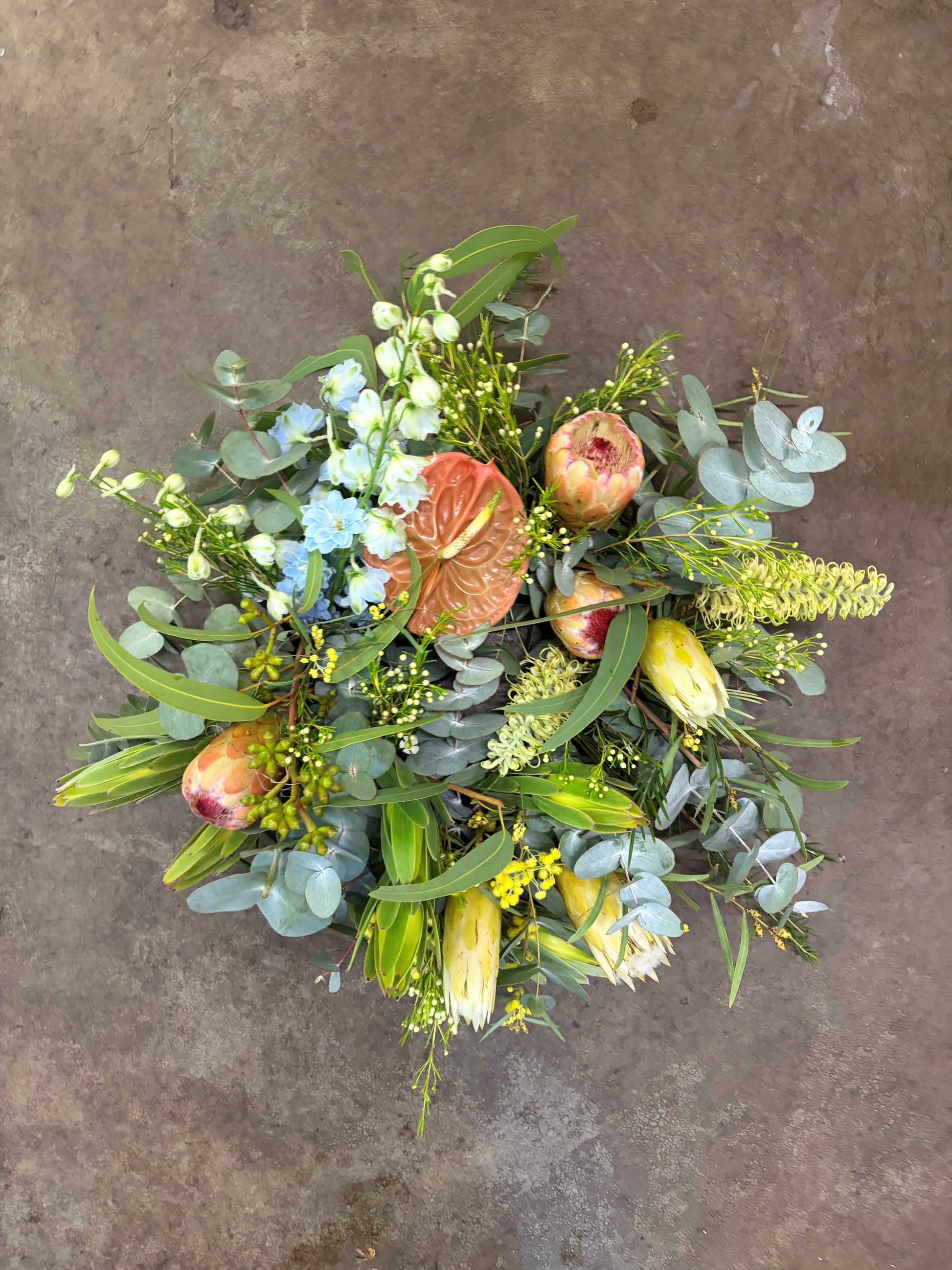 Bouquet of flowers and pomegranates on a textured surface