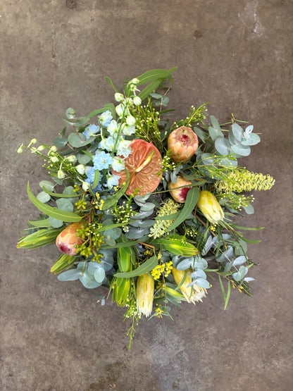 Bouquet of flowers and pomegranates on a textured surface