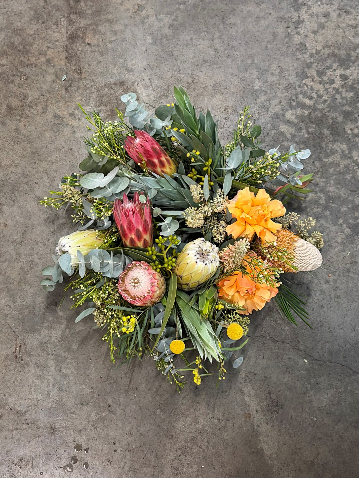 Colorful wreath of flowers on a textured gray surface